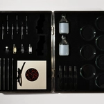 Eduardo Kac, "Cypher", DIY transgenic kit with Petri dishes, agar, nutrients, streaking loops, pipettes, test tubes, synthetic DNA, booklet, 33 x 43 cm, 2009.