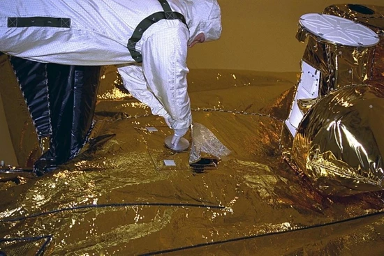 NASA/JPL-Caltech, A Jet Propulsion Laboratory technician inserts the DVD containing Kac's Monogram and many other files into a shallow cavity between two pieces of aluminum that protected it from micrometeoroid impacts.